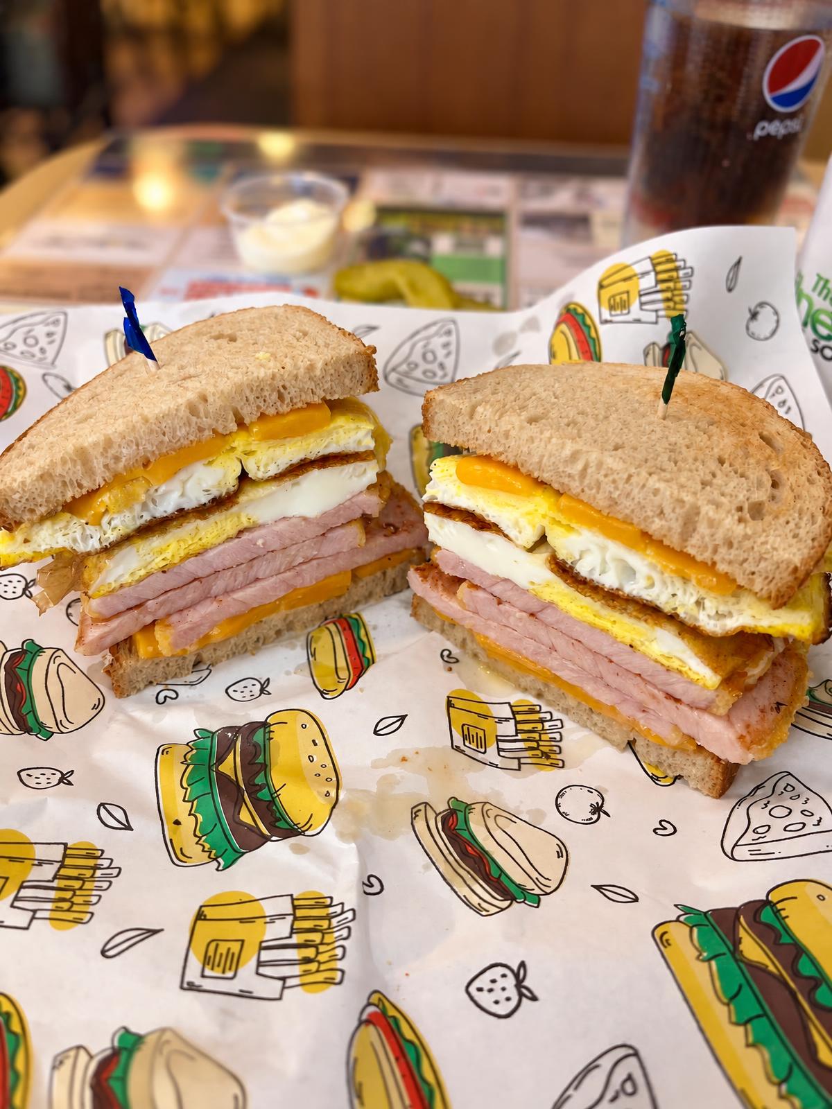 Clubhouse sandwich stacked with egg, ham and cheese